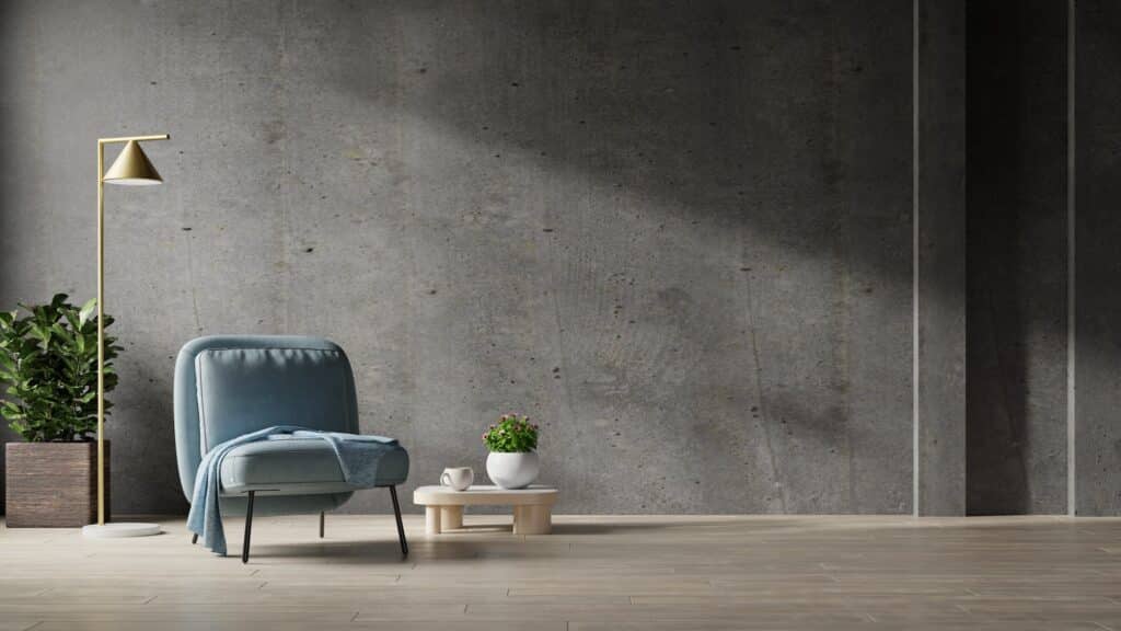 Blue armchairs standing on wood flooring in concrete wall empty room.